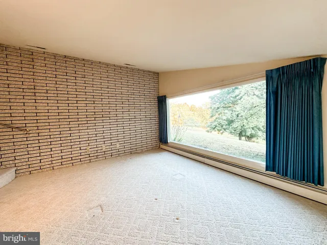 a view of a room with a large window