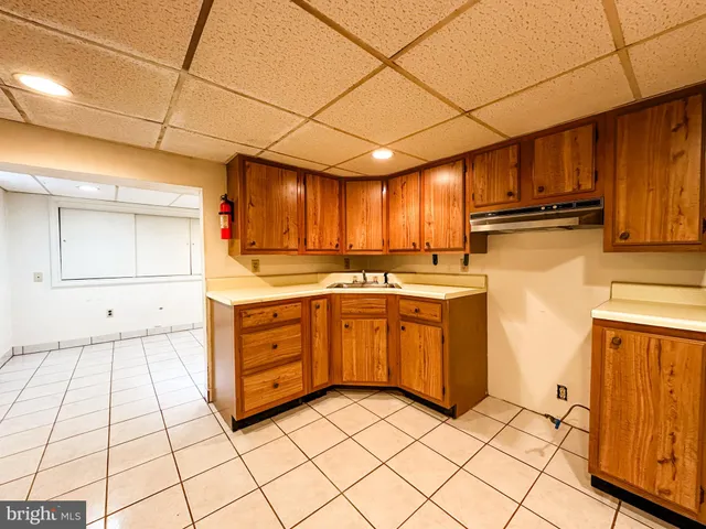 a kitchen with stainless steel appliances granite countertop a sink refrigerator and cabinets