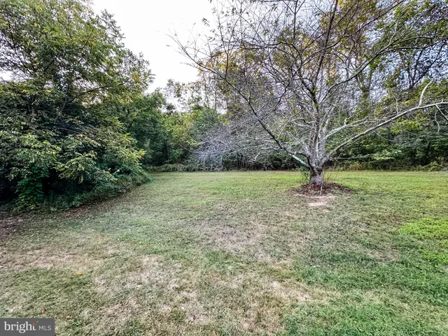 a backyard of a house with yard and outdoor seating