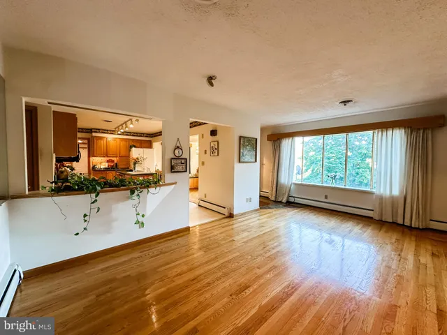 a view of a room with wooden floor and fan