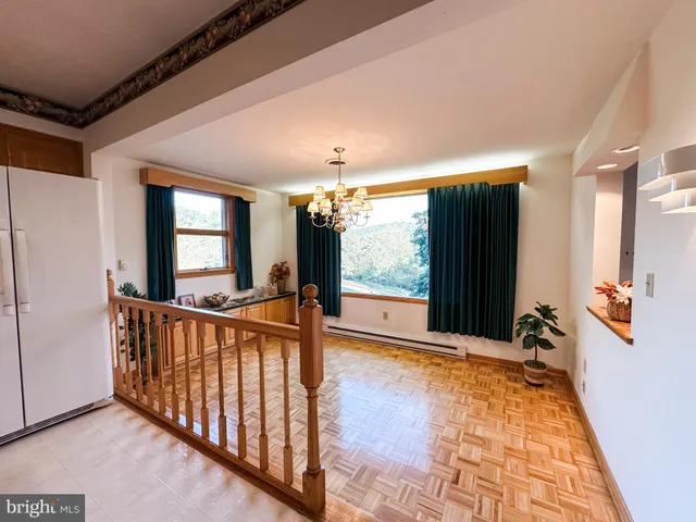 a view of hallway with furniture and a large window