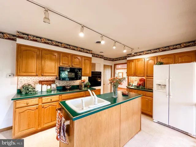 a kitchen with stainless steel appliances granite countertop a sink and cabinets