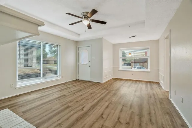 a view of an empty room with a fireplace and a window