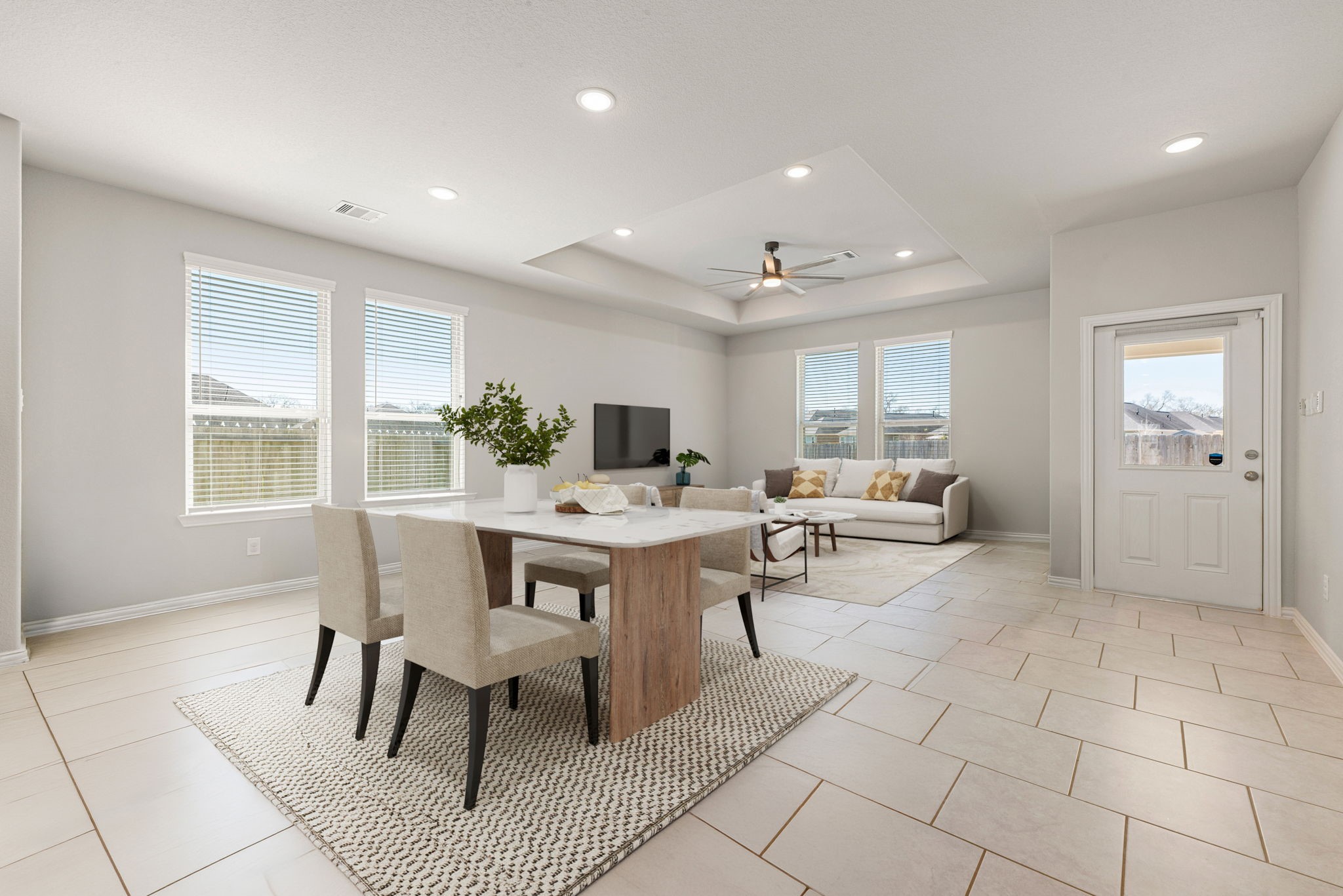 8414 Divot Trace Fulshear, TX 77441 - Photo 10 of 25
This light-filled, open-concept living space features neutral-toned tile flooring and a cohesive, modern layout. The expansive room is illuminated by recessed lighting and a contemporary ceiling fan, while large windows invite an abundance of natural light. Crisp white walls and clean architectural lines create a bright, airy atmosphere that flows seamlessly from the entry to the heart of the home.