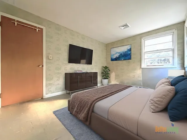 a bedroom with a bed and a fireplace