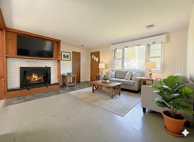 a living room with furniture flat screen tv and a fireplace