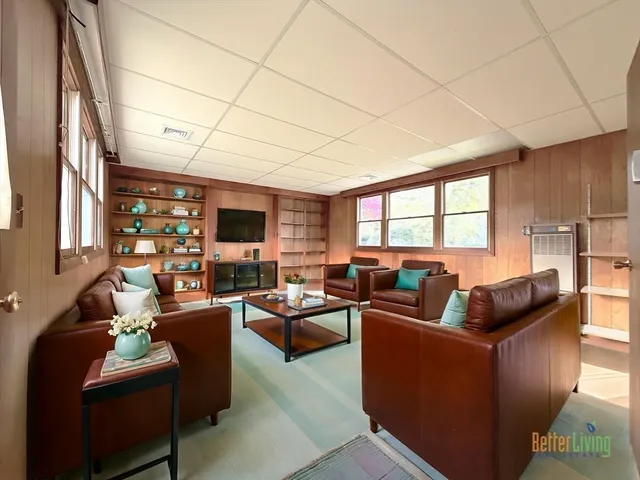 a living room with furniture a flat screen tv and a fireplace
