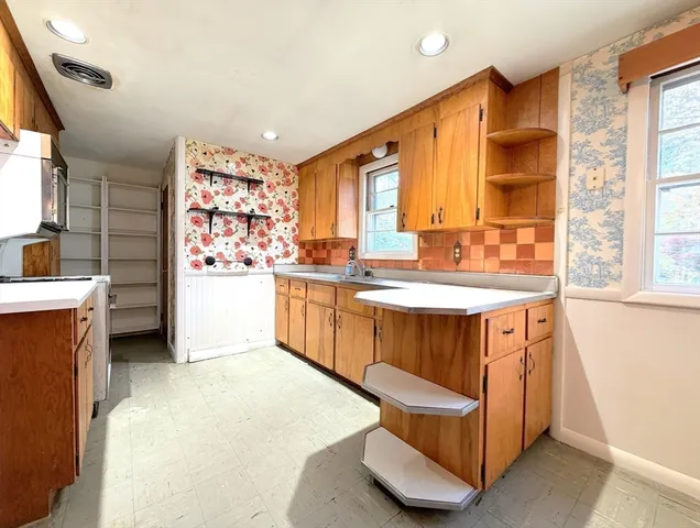 a kitchen with a sink stove and cabinets