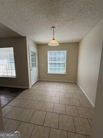 a view of an empty room and wooden floor