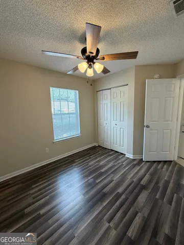 a bathroom with a sink a toilet a mirror and shower