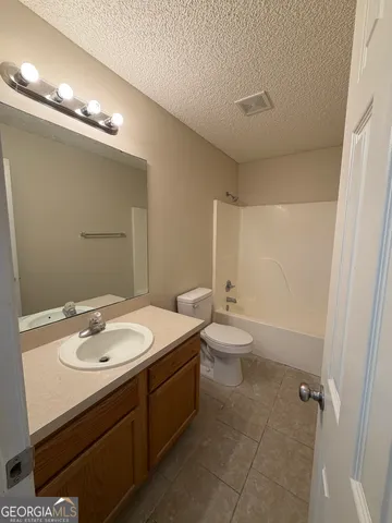 a view of an empty room and wooden floor