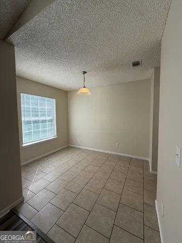 a kitchen with a stove cabinets and a refrigerator