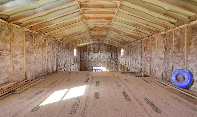 a view of a backyard and basketball court