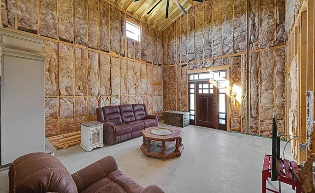 a living room with furniture and a floor to ceiling window
