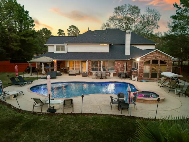 a view of a house with swimming pool and sitting area