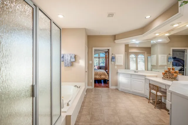 a bathroom with a bathtub and a shower