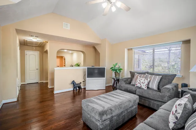 a living room with furniture and a workspace