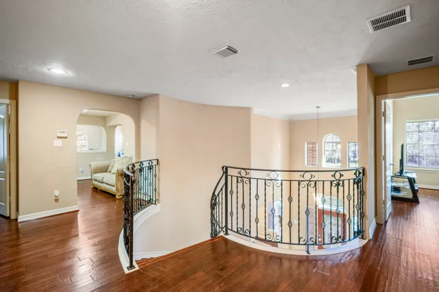 a bedroom with bed and wooden floor