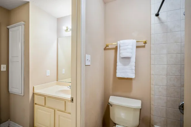 a bedroom with a bed and a potted plant