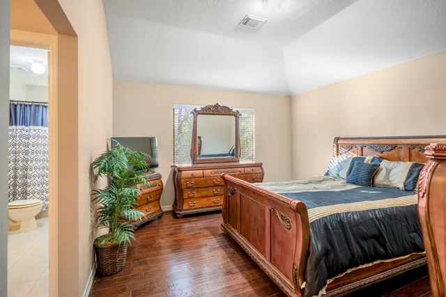 a bathroom with a sink vanity mirror and toilet