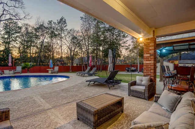 a view of a house with swimming pool and sitting area
