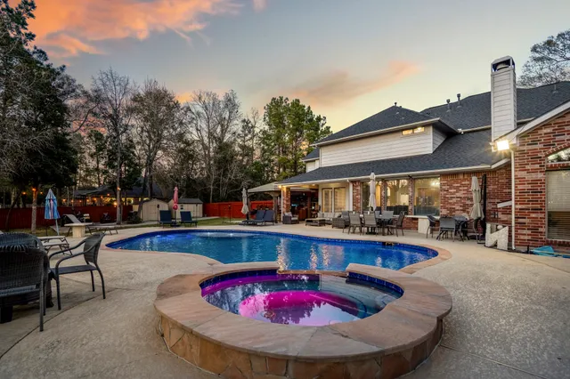 a swimming pool with outdoor seating and yard