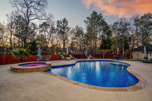 a view of a swimming pool with sitting area