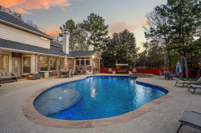 a view of a backyard with large trees