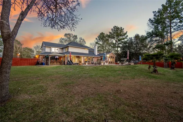 a view of a yard with wooden fence