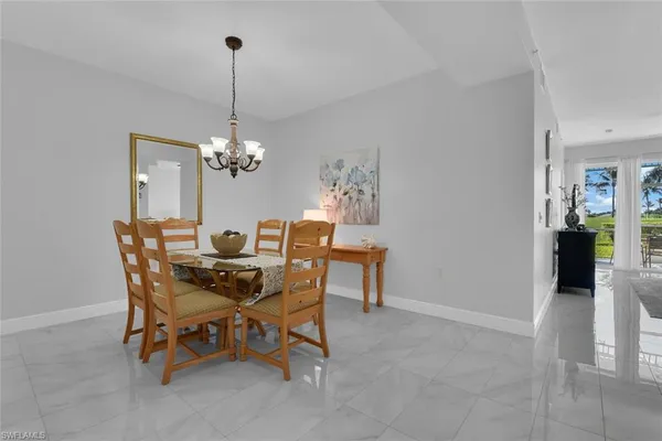 a dining room with furniture and chandelier
