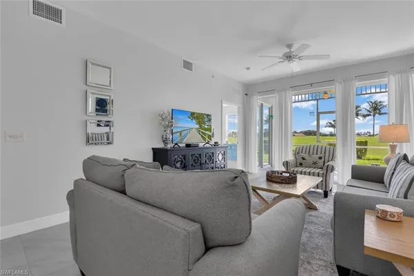 a living room with furniture and a large window