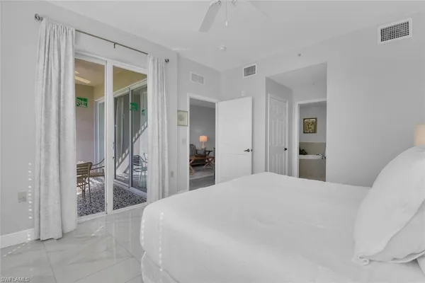 a bedroom with a bed and a large mirror