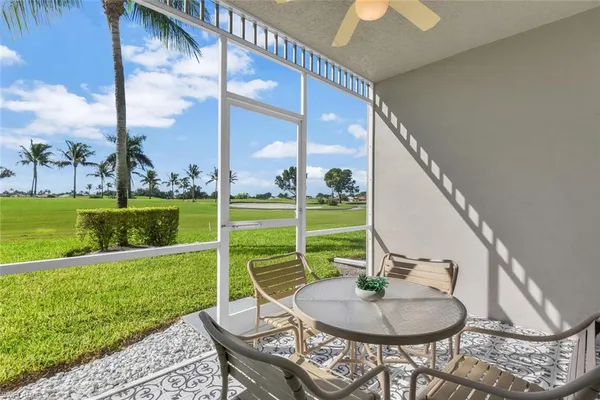 a backyard of a house with table and chairs