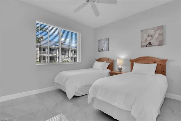 a bedroom with two beds and a window