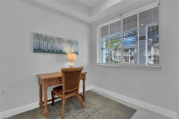 a workspace room with furniture and a window