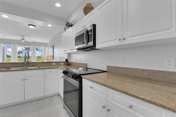 a kitchen with stainless steel appliances granite countertop a sink and a stove