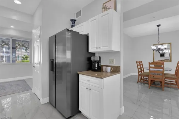 a kitchen with stainless steel appliances granite countertop a refrigerator and a stove top oven