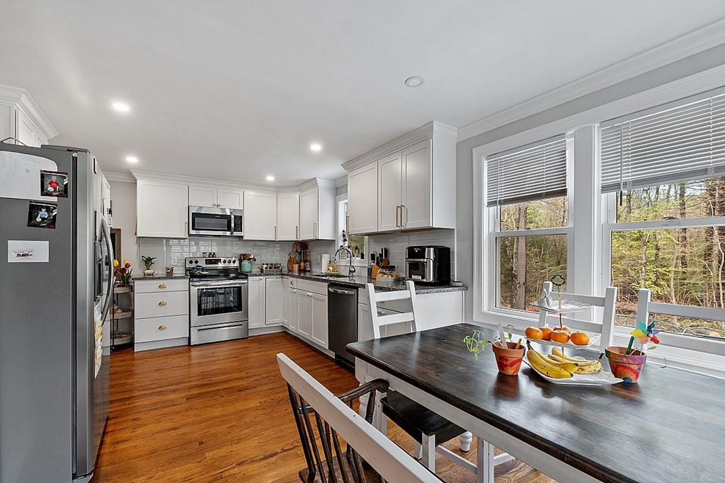 28 Banner Road Gardner, MA 01440 - Photo 5 of 31 a kitchen with stainless steel appliances a stove a sink and a refrigerator