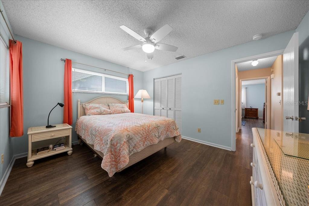 8720 Southwest 90th Street, Unit A Ocala, FL 34481 - Photo 29 of 71 a bedroom with a bed and a chandelier