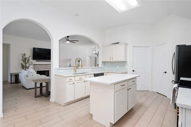 a kitchen with a sink stove and refrigerator