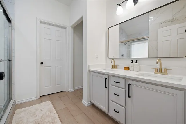 a bathroom with a glass shower door