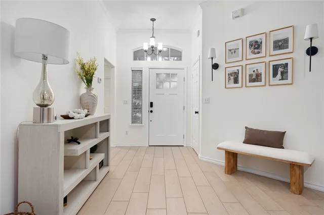 a spacious bedroom with a bed and a chandelier