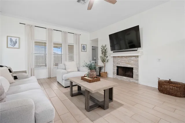 a living room with furniture a flat screen tv and a fireplace