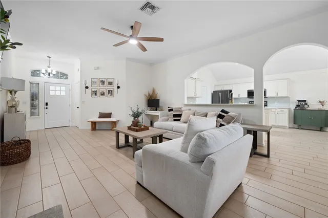 a living room with furniture and a large window