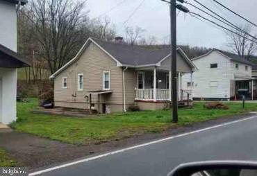 a view of a house with a yard and fence