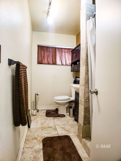 256 North Norma Street Ridgecrest, CA 93555 - Photo 19 of 35 a bathroom with a sink and a toilet