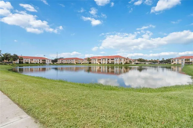 a view of a lake with houses in the back