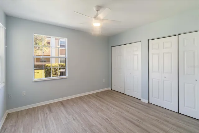 an empty room with wooden floor and a window
