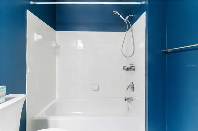 a view of a lake with a big yard and large trees