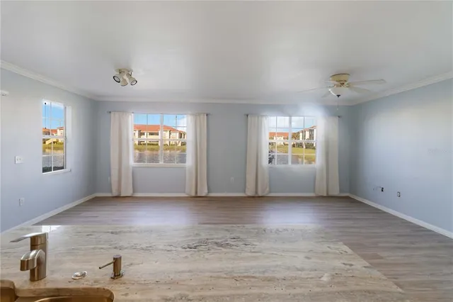 a kitchen with a sink a microwave a refrigerator and cabinets